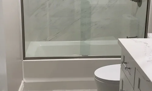 A bathroom with a sink, toilet, and shower